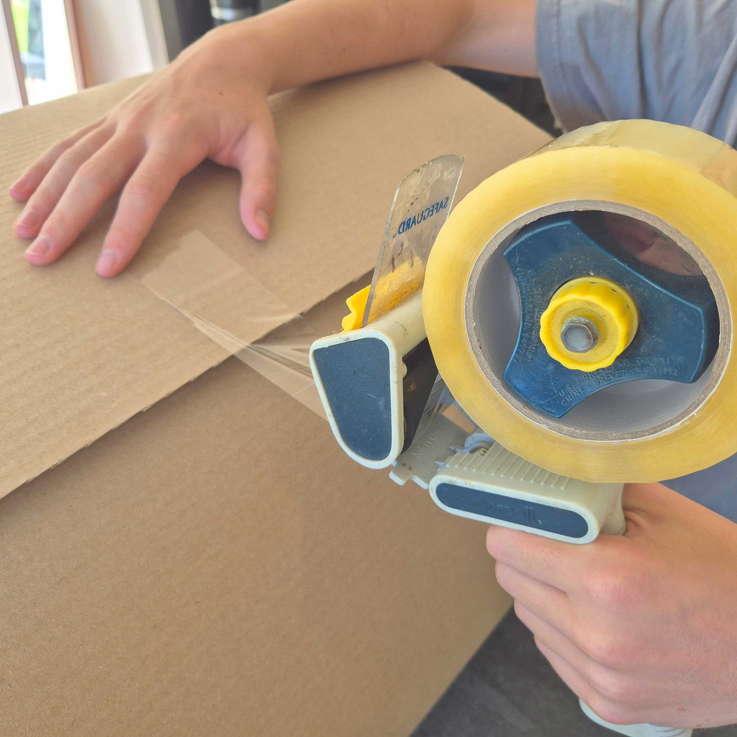 Strong packing tape used to seal cardboard moving boxes