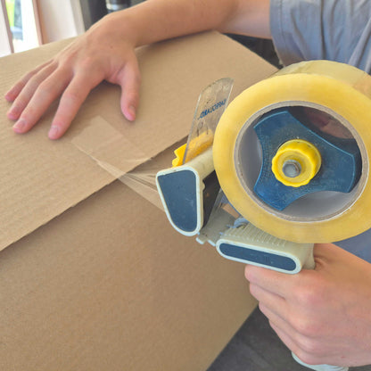 Strong packing tape used to seal cardboard moving boxes